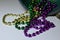 Close up view of traditional Mardi Gras beads on white background