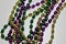 Close up view of traditional Mardi Gras beads on white background