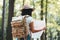 Close-up view on traveling backpack and hipster woman with location map in hands