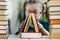 Close-up view on triangle shape to one book standing on another. Little girl on blurred background