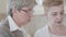 Close up view of two mature women having discussion at home. Senior ladies spend time in the kitchen communicating