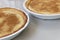 A close up view of two milk tarts in white bowls