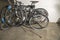 Close up view of two parked bicycles and one of them with flat tire. .