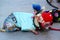 Close up view of two small cute dogs in costumes lying on asphalt. Las Vegas.