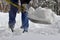 Close up view of an unidentifiable person shoveling deep snow