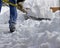 Close up view of an unidentifiable person shoveling deep snow