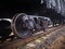 Close up view on used rusted railway freight car bogie with wheel sets with axleboxes, coil springs. Freight train on the railway