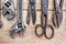 Close up view vintage rusted tools on old wooden table.