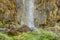 Close up View of a Waterfall in Plitvice Lakes National Park, Croatia, Europe. Water Splashes on the Steep Mossy Rocks