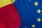 Close-up view of the waving flags of the Romania and European Union