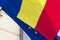 Close-up view of the waving flags of the Romania and European Union. Flag of the EU is hidden with Romanian flag