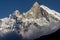 Close-up view of west face of Machapuchare peak Fish Tail emerging from the clouds in Nepal
