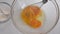 Close up view of whipping fresh eggs in a bowl with electric whisk