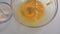 Close up view of whipping fresh eggs in a bowl with electric whisk