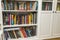 Close up view of white bookshelves with colorful books.