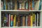 Close up view of white bookshelves with colorful books.