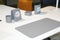 close up view of white desktop with grey accessories for successful work and shiny metal clock