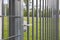 A close-up view of the white handle on the steel fence gate.