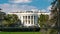 Close up view of the White House presidential residence from the South Lawn side framed by trees in Washington DC with iron