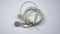 Close up view of a white tangled wired earphone on an  white background