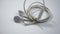 Close up view of a white tangled wired earphone on an  white background