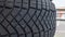 Close-up view of the winter tread of a new tire in shop. Automobile tire for snow road. Selective focus