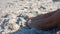 Close up view of woman foot on sand