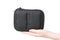 Close up view of woman hand holding black case for batteries for quadcopter