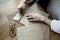 Close-up view of woman hands with hipster envelops cafe near window