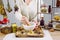 Close up view of woman herbalist mixing various dried herbs for traditional medicinal tea with mortar and pestle.