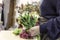 Close up view of a woman holding a bouquet of colourful flowers in a flowers shop in town