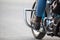 Close-up view at the woman legs with protective boots on stands of chopper motorcycle, copyspace