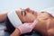 Close up view of woman that lying down in spa salon and have face cleaning procedure by cosmetologist in gloves