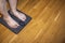 Close up view of woman\'s feet on electrical ems foot massager pad. Feet acupuncture simulator.