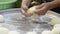 Close-up view of woman`s hand preparation dough in tray for making bread