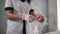 Close up view of woman`s hands, beautician is preparing for the client - putting on the transparent gloves. Preparations