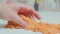 Close-up view of woman\'s hands with kinetic sand of bright orange Anti-stress