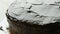 Close up view. Woman spreading a hocolate glaze on a sponge cake. Female hand pour cream with a knife on the cake and