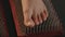 Close up view of woman standing on nails during yoga class. Cropped view of female foot on the sadhu board. Spiritual