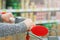 Close up view of a women`s hands with pushcart in supermarket