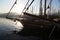 Close-up view of wooden boats moored to the harbor in the morning reverse light