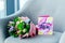 close up view of wrapped bouquet of flowers and i love you mom greeting postcard on armchair, mothers