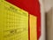 Close up view of yellow calender showing year planner january 2020 and march 2020 pinned on a red board with blurred background