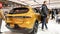 Close up view of yellow dodge GT car on display. Crowds looking at new car models at Auto show. National Canadian Auto Show with