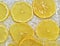 Close-up view of the yellow lemon slices in lemonade background. Texture of cooling sweet summer drink with macro