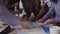 Close-up view of young business team with female team leader working together near the table, actively brainstorming.