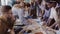 Close-up view of young business team working together near the table, brainstorming. Two mans fist greeting each other.