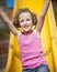 Close-up view of young girl on slide in playground