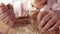 Close up view of young manâ€™s hands breaking bread loaf at table. Cuisine, customs and traditions. Hospitality