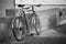 Close up vintage bicycle laying near a wall,black and white picture style,dark edges,selective focus